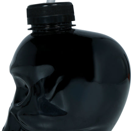 Tasse noire en forme de crâne avec une paille